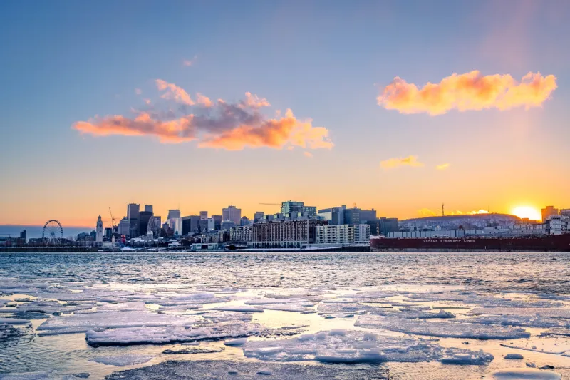 montreal at sunset in winter, view of the st lawrence river covered with ice