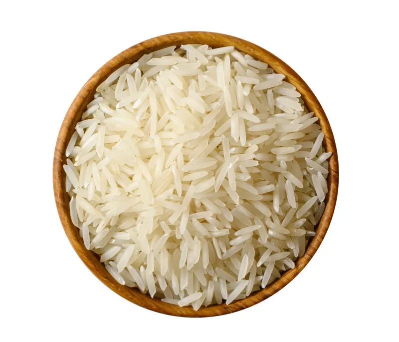 wooden bowl with white long rice basmati isolated on white background top view