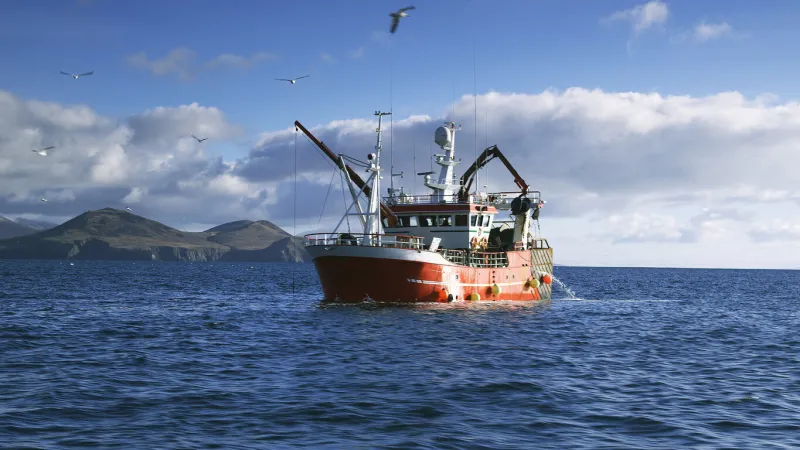 fishing boat on atlantic ocean at dingle peninsula in ireland