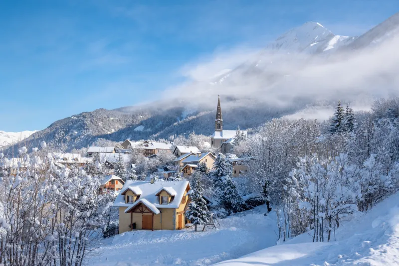 the village of saint leger les melezes in the champsaur valley of hautes-alpes covered in snow in winter ski resort in the ecrins national park, french alps, france