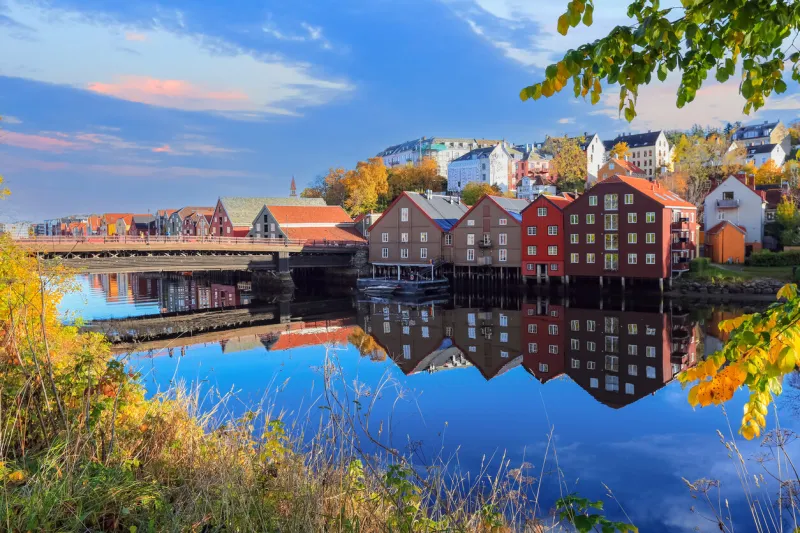 indian summer in trondheim, view of the river nidelva, the old bridge ( den gamle bybro) and old timber buildings along the river