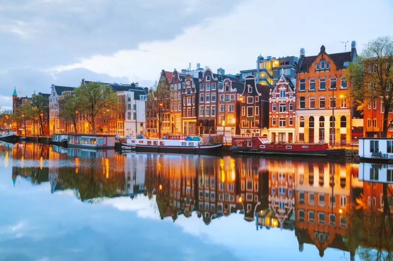 night city view of amsterdam, the netherlands with amstel river