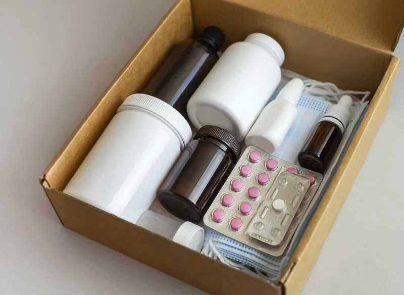 packed box with medicines and medical masks