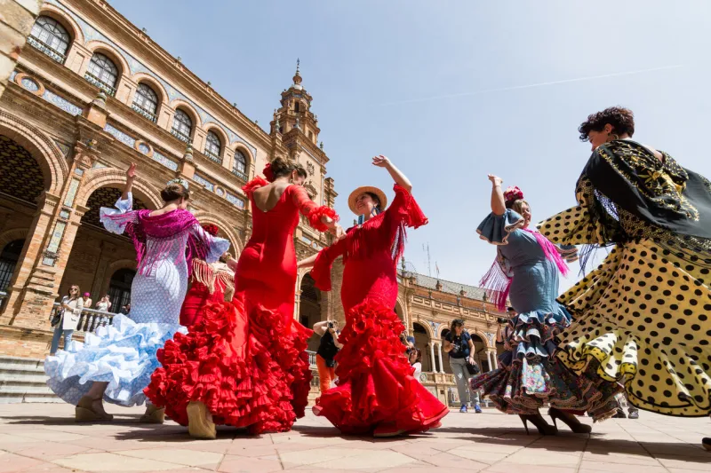 seville, spain - may 2017  young women dance flamenco on plaza de espana during famous feria festival
