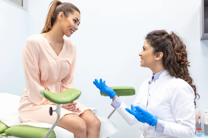 gynecologist talking with a young female patient during a medical consultation in the gynecological office