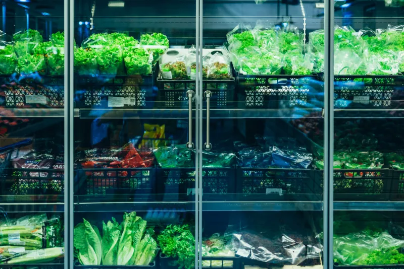 fridge in store with salad green healthy food concept
