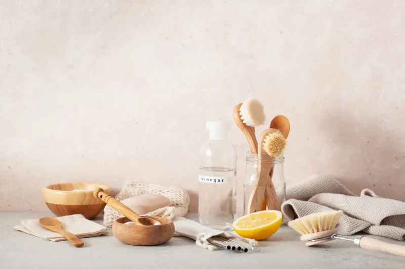zero waste eco friendly cleaning concept wooden brushes, lemon, baking soda, vinegar