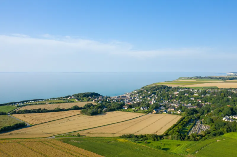 this landscape photo was taken in europe, france, normandy, seine maritime, summer we see the city of veules les roses on the edge of the channel sea, under the sun