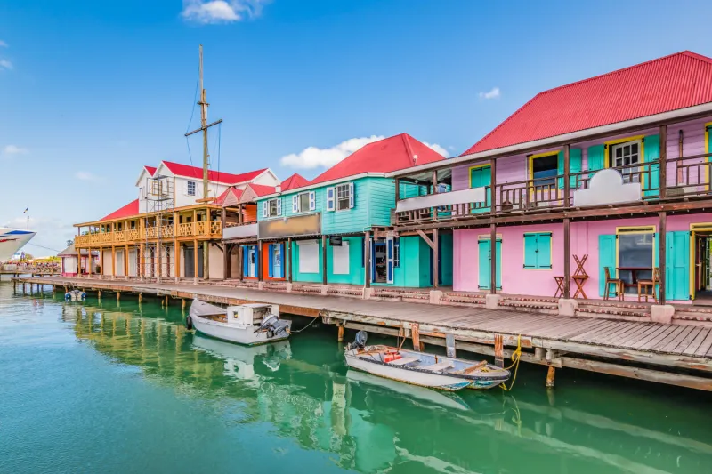 bright image with colorful houses and shops along the waterfront at the port of st john's, antigua and barbuda, caribbean popular cruise destination