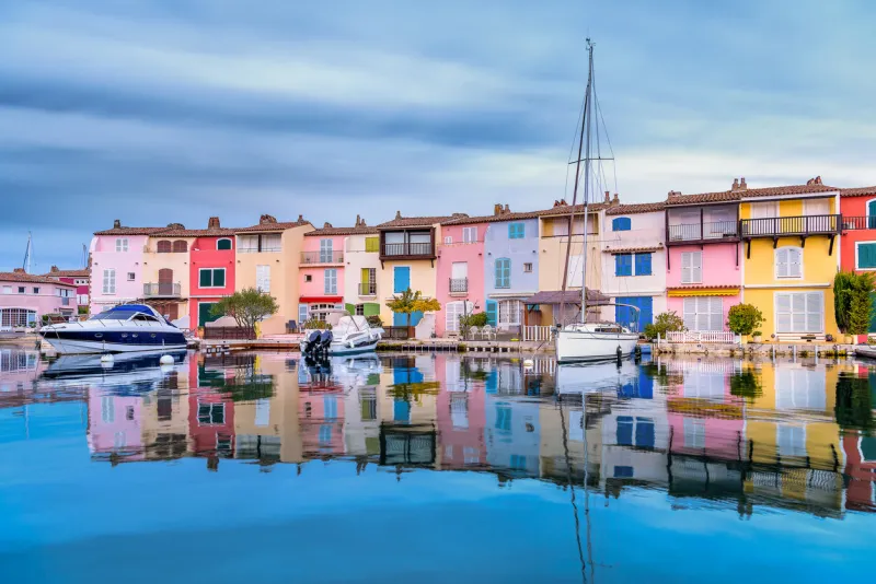 scenic view of port grimaud village in south of france in autumn pastel colors against dramatic sky