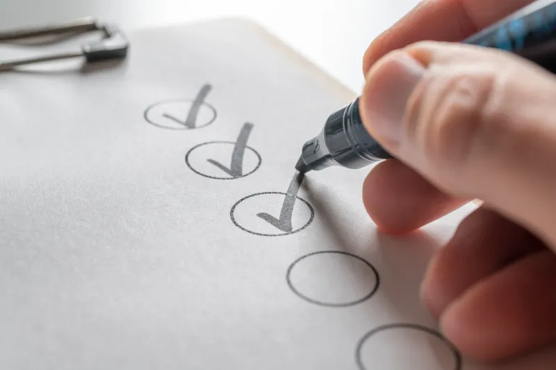 check off a to-do list with a black pen