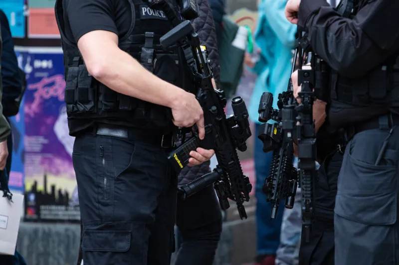 leeds, united kingdom – may 05, 2019  horizontal shot of armed police patrolling tour de yorkshire crowd to keep everyone safe