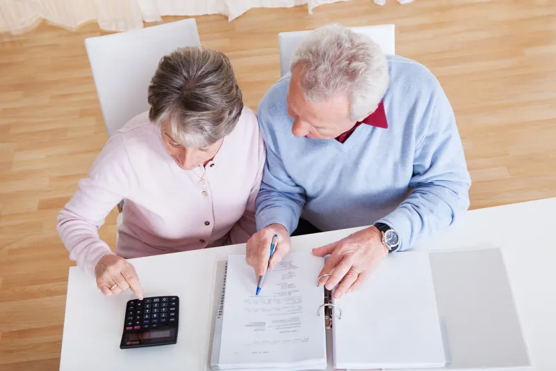 photo of senior couple calculating budget at home
