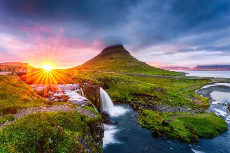 fantastic landscape of sunset shining over kirkjufell mountain with waterfall and pileus cloud in summer at snaefellsnes peninsula, iceland