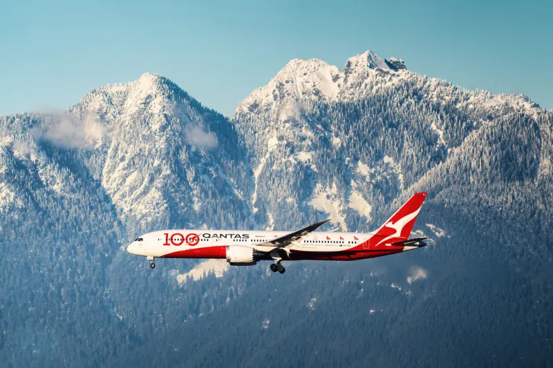 qantas boeing 787 100th anniversary livery flying in front of mountains on final for vancouver international airportdate  dec 20