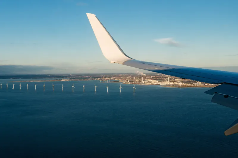 a boeing 737 of ryanair low cost company landing at copenhagen kastrup airport view of the north sea cost of copenhagen and wind turbines