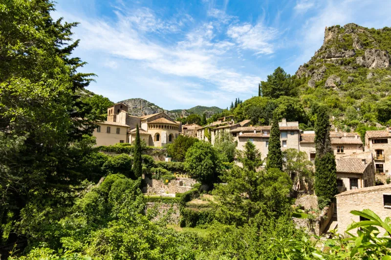 summer view of the medieval village of saint-guilhem-le-désert (occitanie, france)
