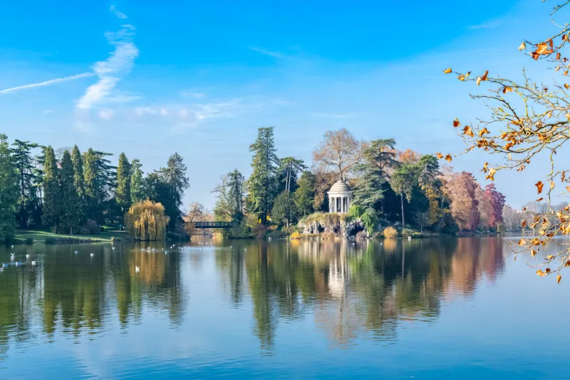 vincennes, the temple of love and artificial grotto on the daumesnil lake, in the public park, in autumn