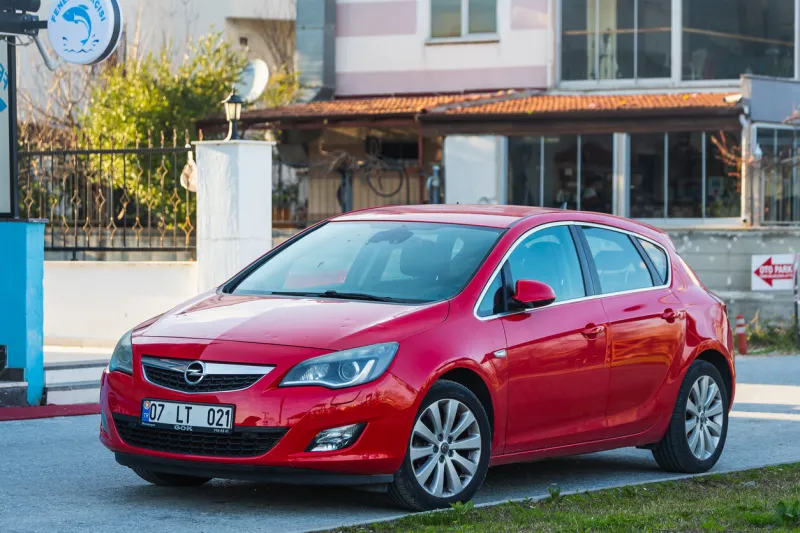 side, turkey – march 05 2022   red opel astra  is parked on the street on a warm summer day