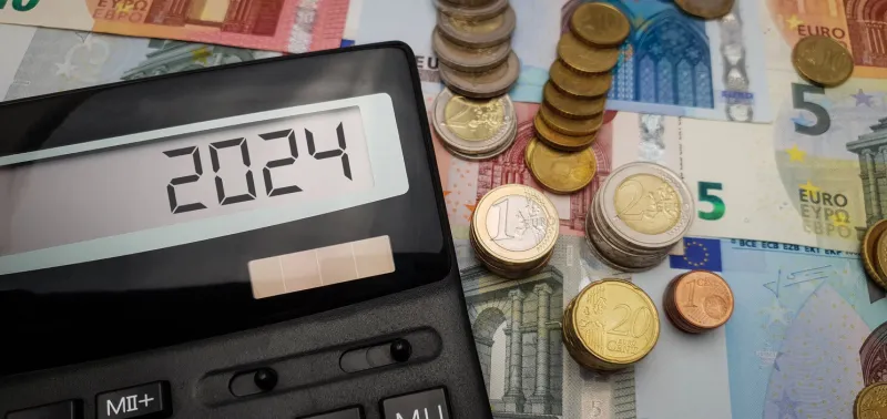 europe's 2024 energy and financial crisis soaring costs of energy, food, and goods calculator surrounded by euro coins and banknotes