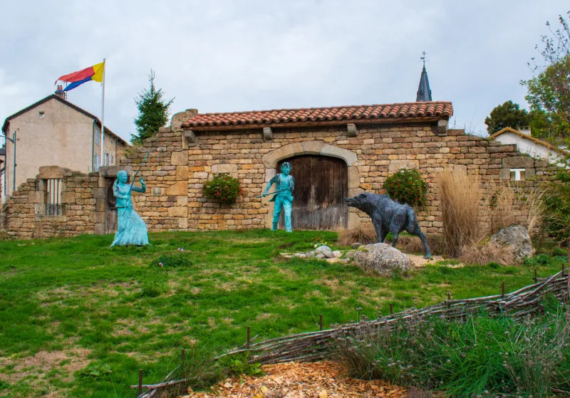 le malzieu, france - 10 29 2023   statues at the entrance to the village representing villagers fighting the beast of gévaudan
