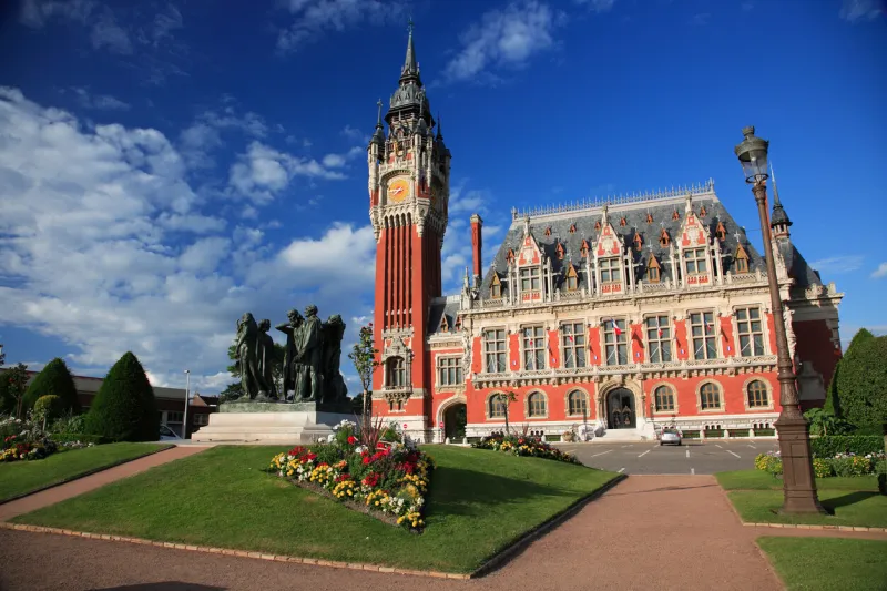 the town hall in calais, france in the late evening