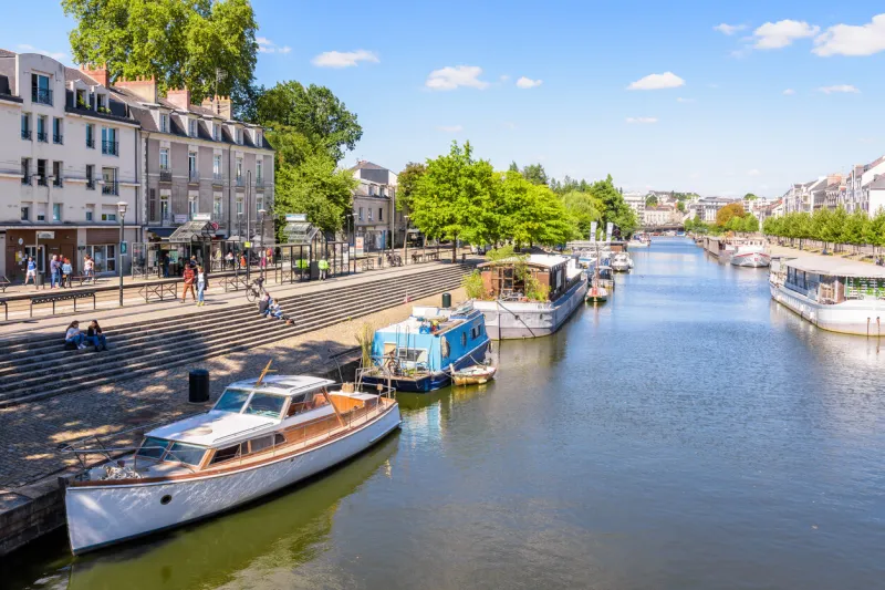 nantes, france - september 19, 2022  general view of the erdre river with houseboats and pleasure boats moored at dock on a sunny summer day