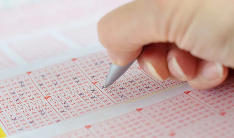 lottery ticket with crossed numbers and pen