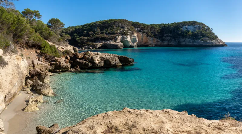 landscape view of the idyllic and peaceful cala mitjana in southern menorca
