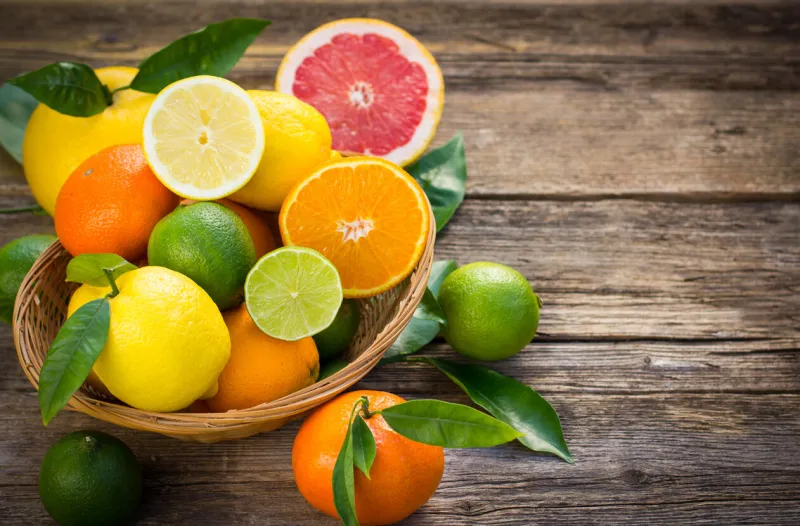 citrus fruits in the basket on the rustic table
