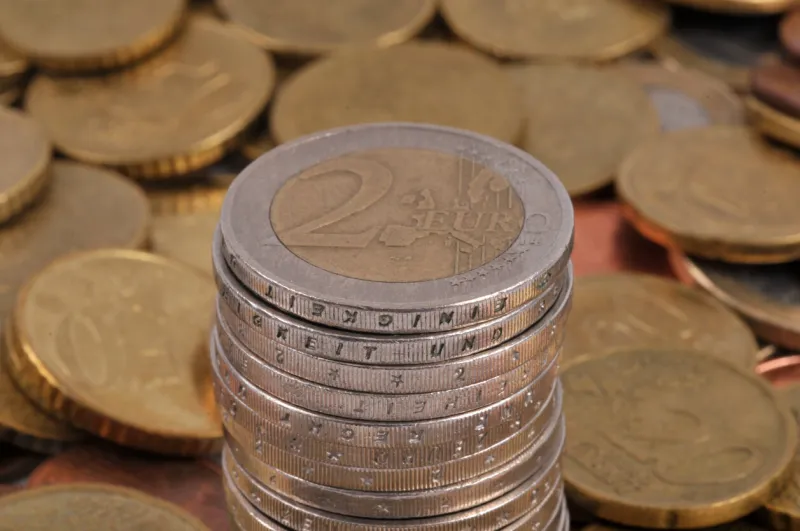 stack of two euro coins close-up on a background of coins