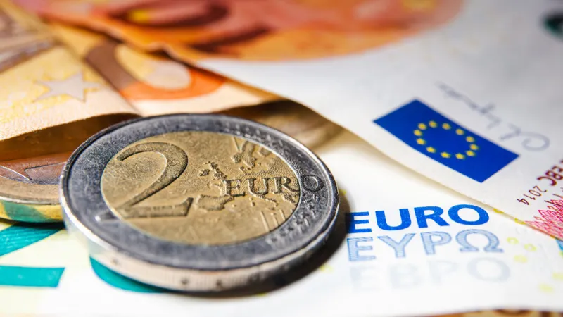 european money euro currency two euro coin and banknotes