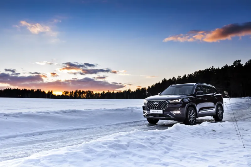moscow, russia - march 19, 2021  chery tiggo 8 pro   plus a purple suv is parked in the forest winter snow drifts, large chinese premium car