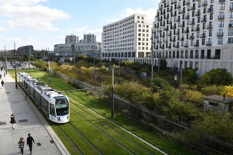 paris, france-10 06 2022  tramway passing nearby modern residential buildings in paris, france