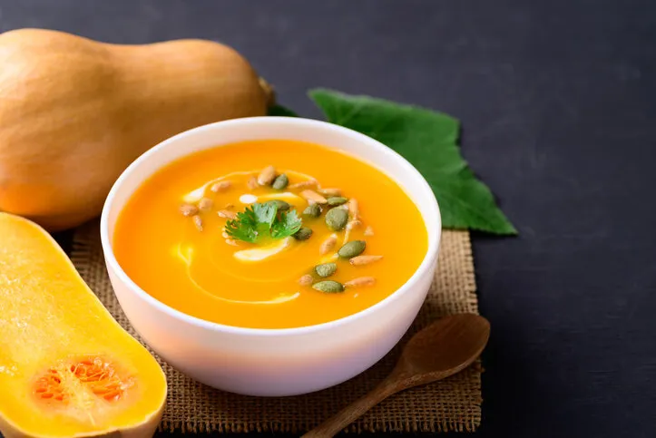 butternut squash pumpkin soup in bowl, homemade food in autumn season
