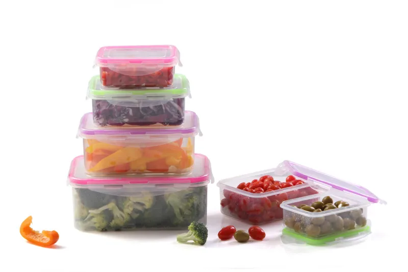 various plastic containers for storing food and fruit , food inside plastic containers on a blue wooden background