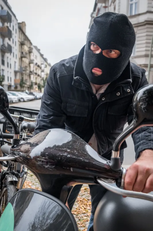 theft wearing a balaclava stealing a scooter
