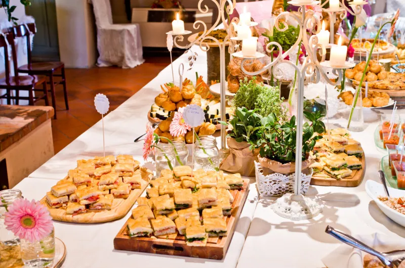 true buffet tables with canapés, sandwiches, cold cuts, cheeses ready for an aperitif or appetizer