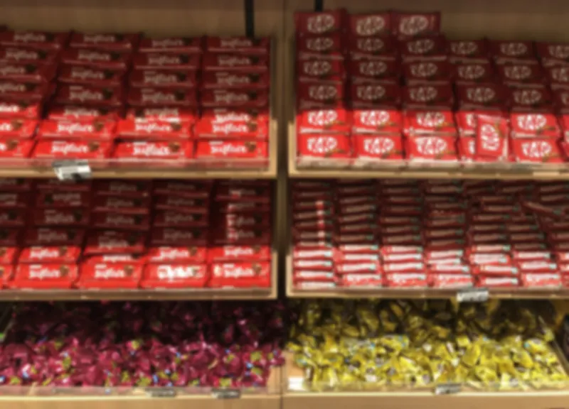 a shelf full of desserts and chocolates, of brazilian brands in a supermarket
