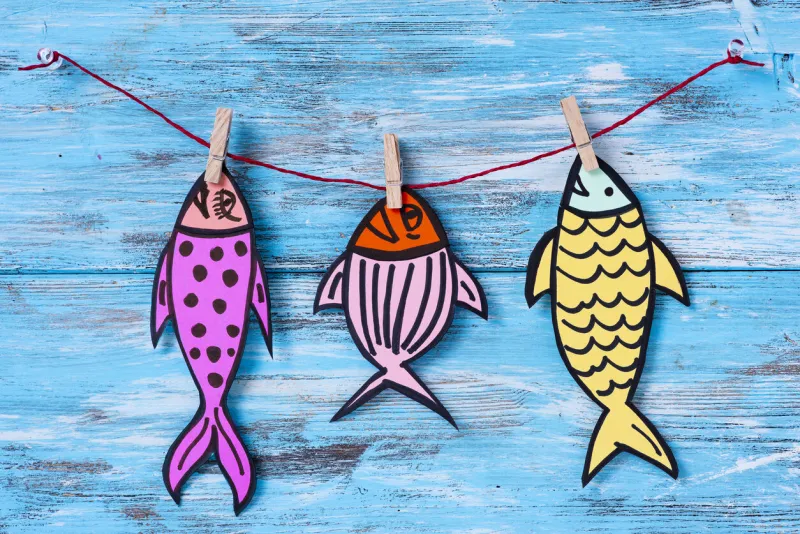 some homemade paper fishes, made by myself, as a popular prank for april fools day in countries such as italy, france, belgium, netherlands, switzerland or canada hanging from a rope with clothespins