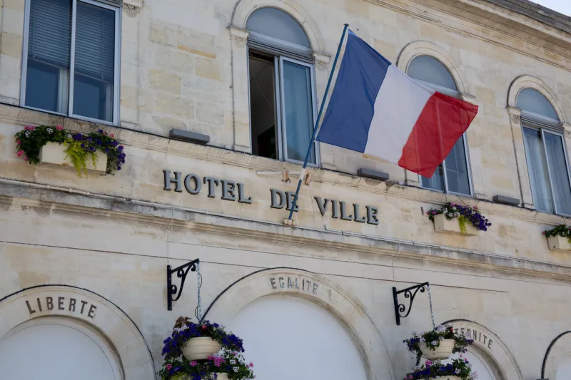 french flag waving over one city hall