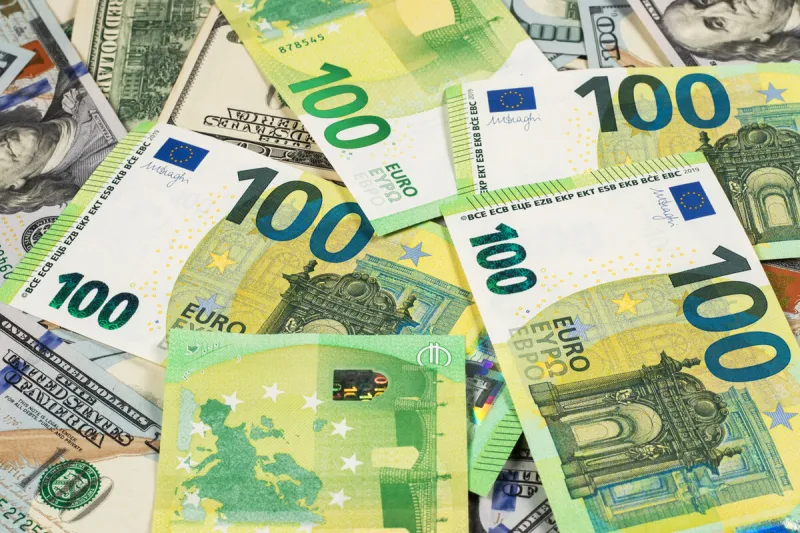 many 100 dollars and 100 euro banknotes background