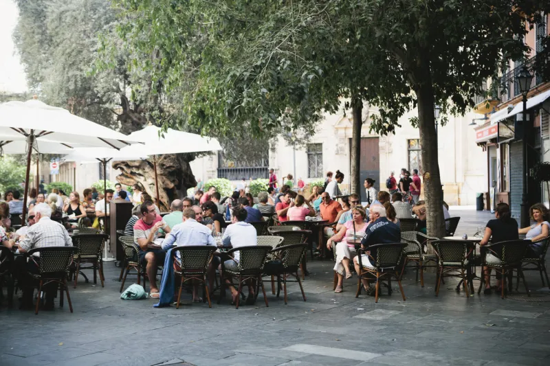 crowd seated outside restaurant in palma, majorca
