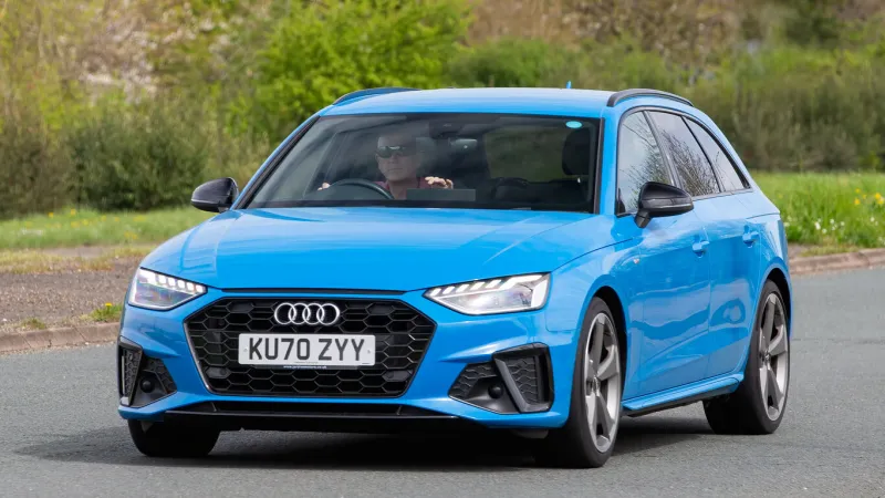 milton keynes,uk- apr 8th 2024 2020 blue audi a4 diesel engine car driving on a british road