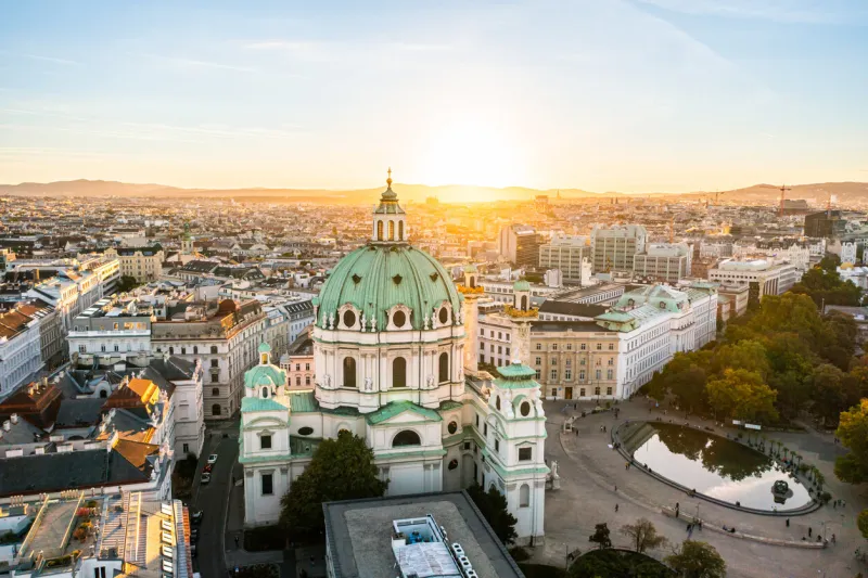 aerial drone photo - st charles church karlskirche at sunset vienna, austria