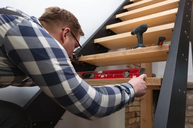 home improvement handyman building staircase in a natural light