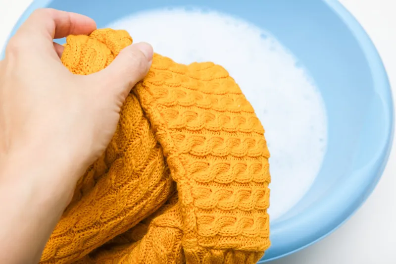 hand washing of delicate woolen knitted clothes, sweaters concept, care of bright color clothes