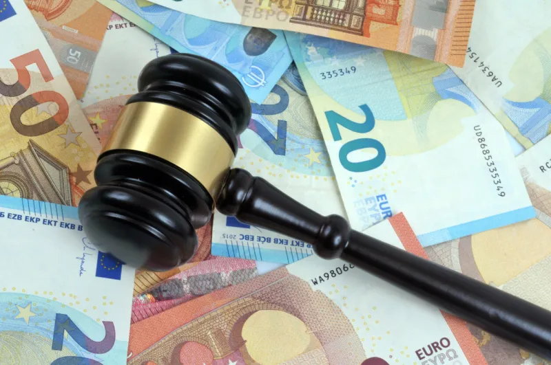 judge gavel lying on euro banknotes