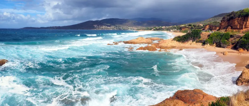 panoramic view of stagnone beach in calcatoggio, corsica (nicknamed the isle of beauty), on a stormy day this beach is a vast expanse of sand over a kilometer long and is located north of ajaccio, on the road to cargèse