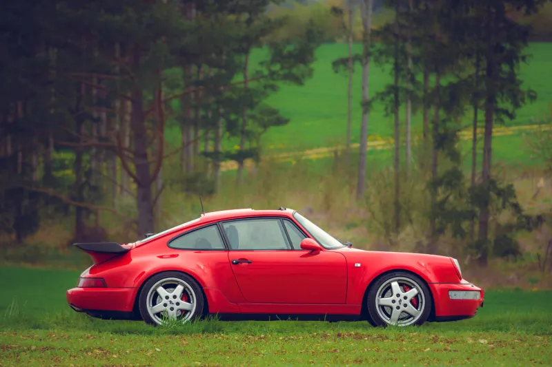 münsingen, germany - may 1, 2023  porsche 911 930 turbo carrera german oldtimer vintage luxury sports car on a country road on a sunny summer day